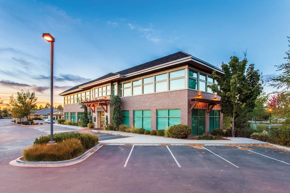 A modern two-story office building in Eagle, ID, captured at sunset with a clear blue sky.