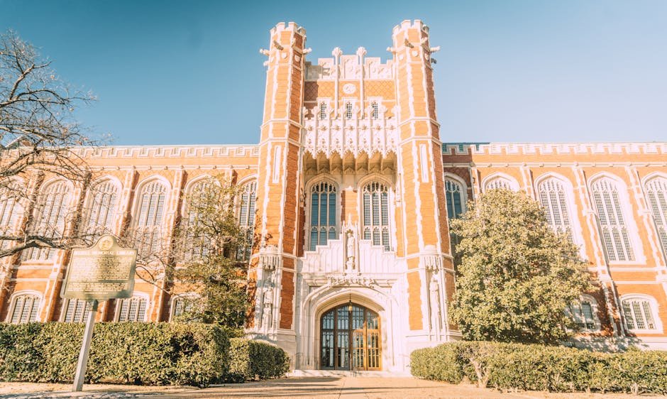 Beautiful Neo-Gothic architecture of the University of Oklahoma under a clear sky.