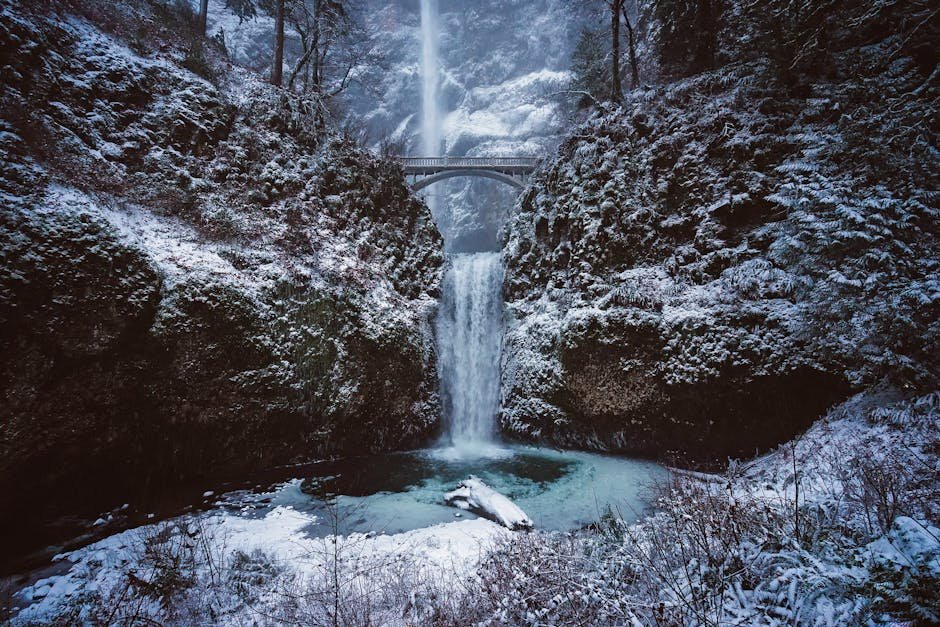 Scenic winter scene of snow-covered Multnomah Falls with a bridge in Oregon.